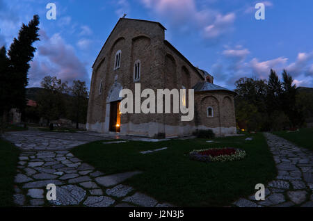 Church inside 12.century Studenica monastery during evening prayer, UNESCO world heritage site in Serbia Stock Photo