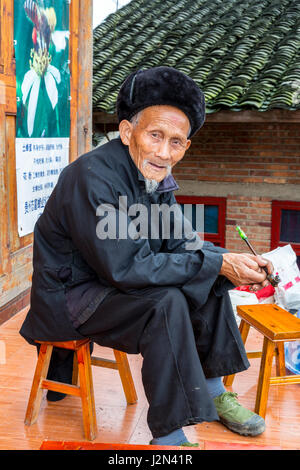 Matang, a Gejia Village in Guizhou, China.  Old Man with his Pipe. Stock Photo