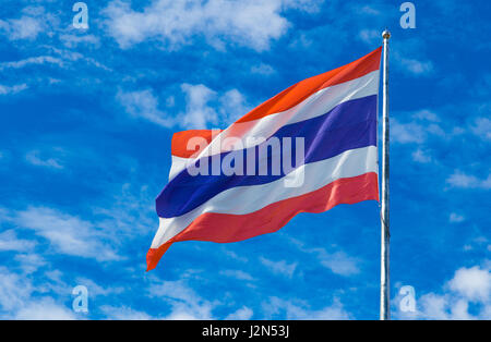 Thailand national flag on the flag pole wind blown against blue sky background Stock Photo