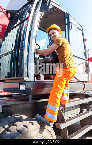 driver gets on his truck in landfill Stock Photo