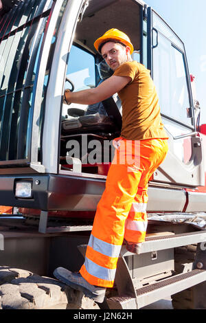 driver gets on his truck in landfill Stock Photo