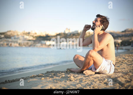 Man sitting on the beach Stock Photo