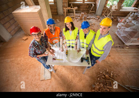 Smiling young construction team on building construction construction, si Stock Photo