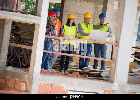 Young engineer team at construction place show building place as planned engineers, architects, team, Stock Photo