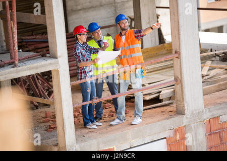 Group of building constructers discussing and Stock Photo