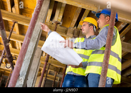 Handsome  architect with supervisor of the construction site show place of build up on construction site Stock Photo