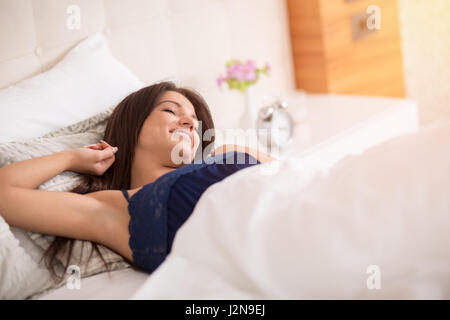 Exhaustion relax dreaming sleep concept. Tired girl sleeping. Young lady  resting in fetal position recovering in bed Stock Photo - Alamy