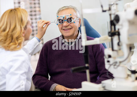 Ocular female specialists work with patient in pleasant atmosphere on eye clinic Stock Photo