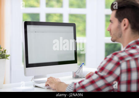 Man sitting front of  computer and working Stock Photo