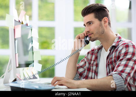 Busy man working on computer Stock Photo