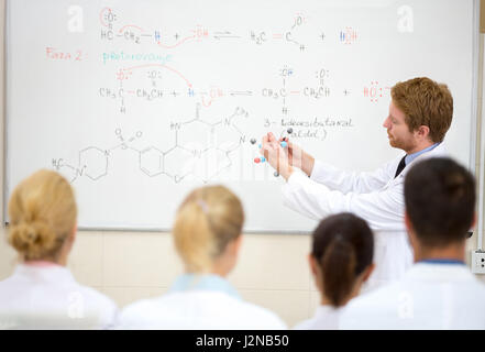 Male chemical professor show molecular model to students in the classroom Stock Photo