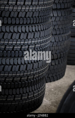 Stack of car tires on warehouse close up Stock Photo