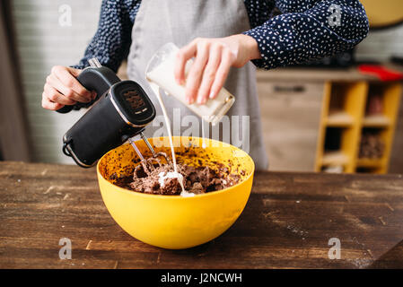 Female person hands mixing cake ingredients. Tasty dessert homemade cooking Stock Photo