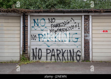 'No Parking' written multiple times on an estate garage in Bermondsey, south east London, UK. Stock Photo