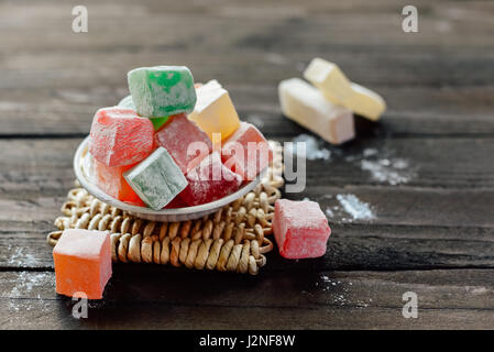 Various color turkish delight lokum with powdered sugar on little plate Stock Photo