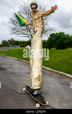 Ballydehob, West Cork, Ireland. 29th April, 2017. Pictured trying out a skateboard before taking part in the Jazz Funeral as part of the annual Ballydehob Jazz Festival was stilt walker Mick Eile from the Sheeps Head. The festival runs until Bank Holiday Monday 1st May. ©Andy Gibson/Alamy Live News. Stock Photo