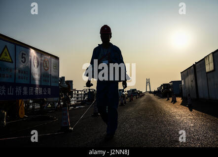 Zhuhai, China's Guangdong Province. 28th Apr, 2017. A builder walks at the construction site of the Hong Kong-Zhuhai-Macao Bridge in Zhuhai, south China's Guangdong Province, April 28, 2017. Credit: Liu Dawei/Xinhua/Alamy Live News Stock Photo