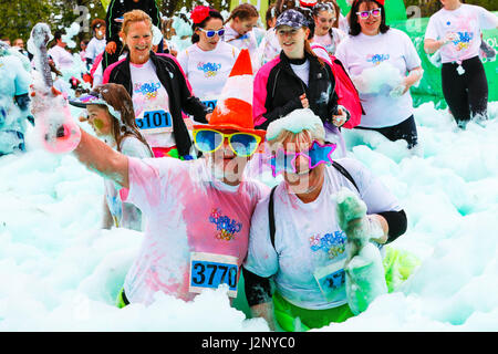 Glasgow, UK. 30th Apr, 2017. Glasgow's Bellahouston Park was transformed into a sea of frothing foamy fun today when 4500 people took part in the sell-out Bubble Rush (the biggest in the UK) to raise money for Scotland's Hospices. Organised by the Prince and Princes of Wales Hospice in Glasgow, the 5k course around the park blasted entrants with cannons of coloured foam and bubbles along the route. Credit: Findlay/Alamy Live News Stock Photo
