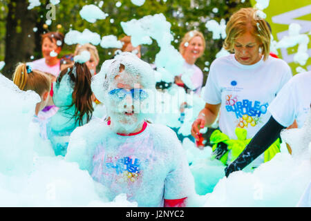 Glasgow, UK. 30th Apr, 2017. Glasgow's Bellahouston Park was transformed into a sea of frothing foamy fun today when 4500 people took part in the sell-out Bubble Rush (the biggest in the UK) to raise money for Scotland's Hospices. Organised by the Prince and Princes of Wales Hospice in Glasgow, the 5k course around the park blasted entrants with cannons of coloured foam and bubbles along the route. Credit: Findlay/Alamy Live News Stock Photo