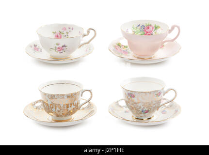 High resolution close-up of four beautiful antique tea cups with saucers isolated on a white background. Stock Photo