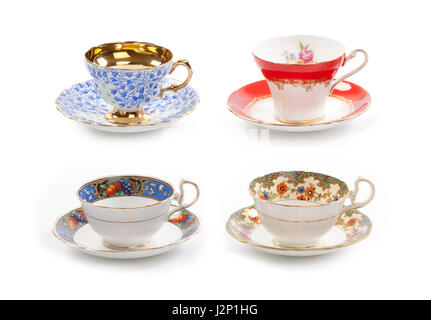 High resolution close-up of four beautiful antique tea cups with saucers isolated on a white background. Stock Photo