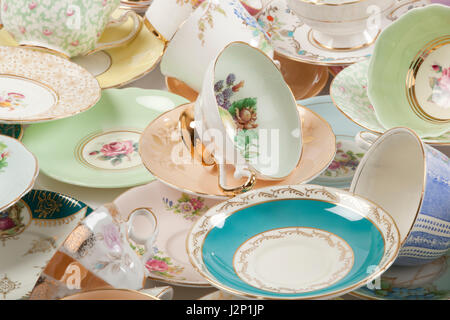 High resolution close-up of a beautiful antique tea cups and saucers collection, isolated on a white background.