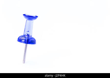 single blue translucent push pin on white paper with room for copyspace Stock Photo