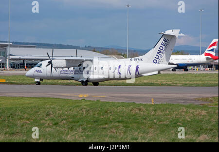 A Dornier 328-100 turboprop 33 seat passenger aircraft arriving at Inverness Dalcross Airport in the Scottish Highlands. Stock Photo