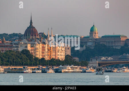 The dome of the Hungarian Parliament Building and the Royal Palace from Danube in Budapest, Hungary Stock Photo