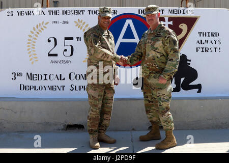 Lt. Gen. Michael Garrett, commanding general of U.S. Army Central and Maj. Gen. William Lee, commanding general of 3rd medical Command (Deployment Support) pose during a brief site visit of a painted mural to celebrate 25 years of partnership between the two commands, April 21 at Camp As Sayliyah. The 3rd Medical Command provides ARCENT Soldiers with access to a variety of specialized capabilities while deployed, such as combat support hospitals, x-ray technology, dentistry, surgeons, and veterinarians. (U.S. Army photo by Sgt. Bethany Huff, ARCENT Public Affairs) Stock Photo