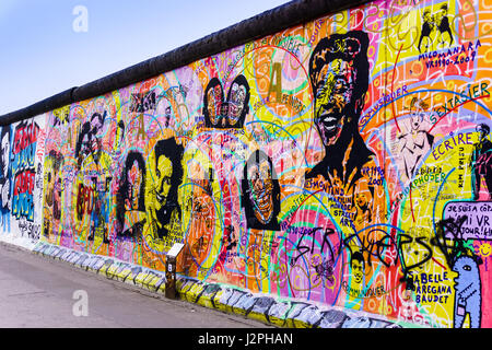 BERLIN, GERMANY - MARCH 20: Graffiti at the East Side Gallery on March 20, 2015 in Berlin, Germany. The East Side Gallery is the longest preserved str Stock Photo