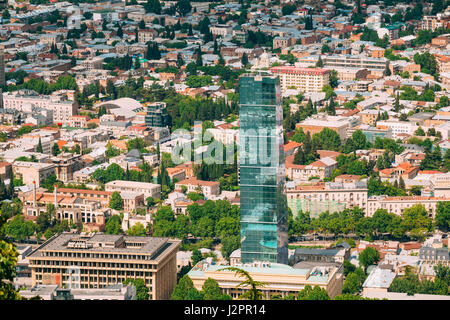 Tbilisi, Georgia - May 20, 2016: Aerial View Of New Glass Skyscraper Of The Biltmore Hotel, Surrounded By Buildings Of Soviet Time In Sunny Summer Day Stock Photo