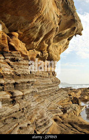 Strata of sedimentary rock on a rugged coastal shoreline. Stock Photo