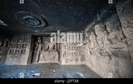 Ellora Caves UNESCO World Heritage Site. Statue of big Buddha, sanctuaries devoted to Buddhism, Hinduism and Jainism. Temples and monasteries near Aur Stock Photo