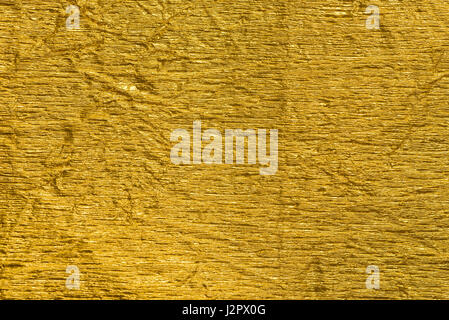 gold color creased metallic foil background texture Stock Photo