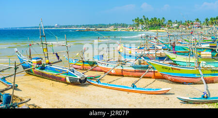 HIKKADUWA, SRI LANKA - DECEMBER 4, 2016: The traditional oruwa boats are the visit cards of Sri Lankan coast and popular tourist attraction, Kumarakan Stock Photo