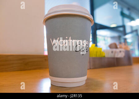 A cup of free coffee at a Waitrose supermarket. UK. This cup is a mixture of paper and plastic and so is hard to recycle. Stock Photo