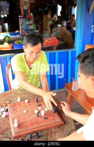 Two men men playing Makruk aka Thai Chess - a south east asian version of the board game Stock Photo