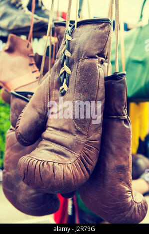 Brown old boxing gloves with a lace in a market Stock Photo