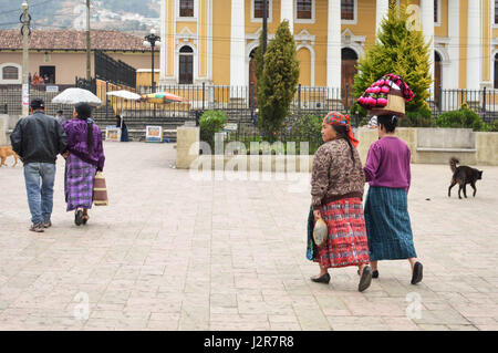 Totonicapan, Guatemala - February 10, 2015: Maya people stroll the main square of a small colonial town of Totonicapan in Guatemala. Central America.  Stock Photo