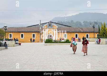 Totonicapan, Guatemala - February 10, 2015: Maya people stroll the main square of a small colonial town of Totonicapan in Guatemala. Central America.  Stock Photo