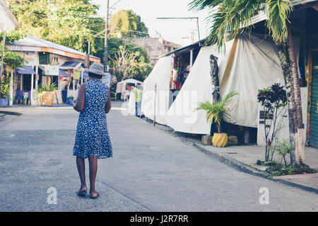 Livingston, Guatemala - March 8, 2015:  Garifuna woman walks up one of the main streets in Livingston, Guatemala. Garifuna are the group of indigenous Stock Photo