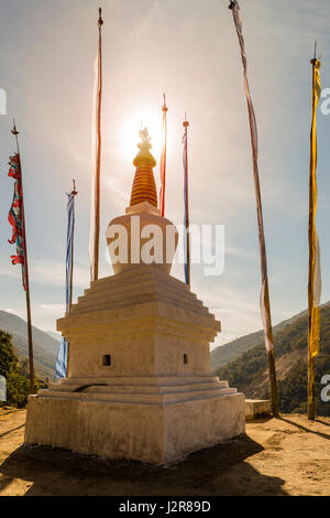 Stupa with prayer flags in sunset (Bhutan) Stock Photo