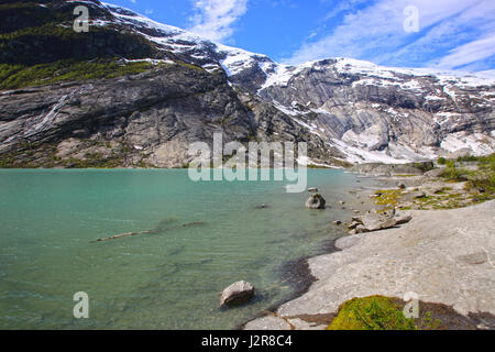 Mountains and green pure lake water near Nigardsbreen Glacier in Jostedalsbreen National Park, Norway Stock Photo