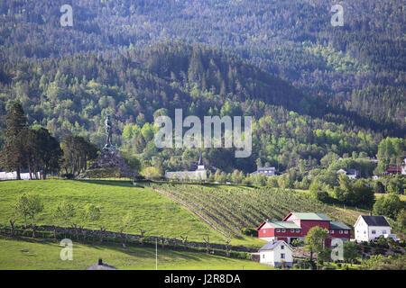 Summer view on landscaped fields and houses of village Vangsnes, Norway Stock Photo