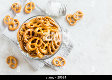 Salty Mini Pretzels with Salt in a Bowl - homemade organic snack for beer Stock Photo
