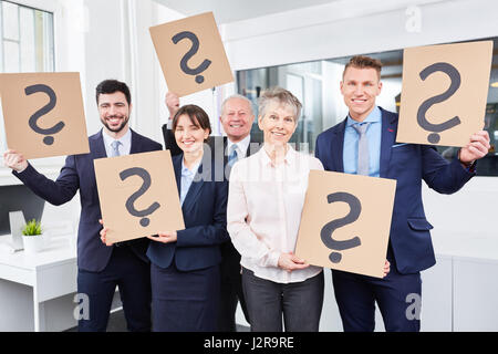 Business team holding question marks in creativity workshop Stock Photo