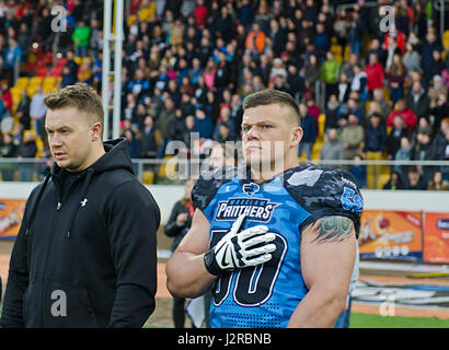 Wroclaw Panthers’ Defensive Lineman, Simon Adamczyk, honors the Polish National Anthem during the opening ceremony at Olympic Stadium in Wroclaw, Poland April 22, 2017. In support of Operation Atlantic Resolve, 3rd Battalion, 29th Field Artillery Regiment, 3rd Armored Brigade Combat Team, 4th Infantry Division, priority is to sustain interoperability with their Polish allies, however, integrating U.S. Soldiers into local events helps strengthen relationships within Polish communities. (Photo by Army Sgt. Justin Geiger, 7th Mobile Public Affairs Detachment) Stock Photo