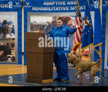 Hanna Stulberg, with her service dog, Valhalla, welcome the Warrior CARE attendees and Warrior Games athletes to the opening ceremony of the two events April 24 at Eglin Air Force Base, Fla. The ceremony kicked off a week-long rehabilitative wounded warrior camp as well as a training session for the Air Force Warrior Games athletes. (U.S. Air Force photo/Samuel King Jr.) Stock Photo