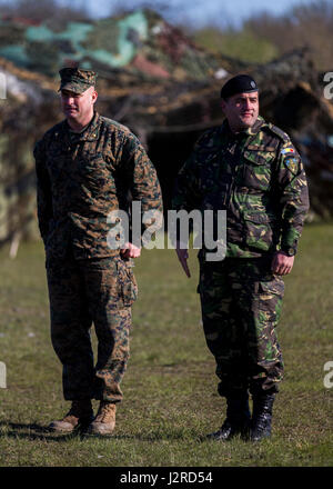 U.S. Marine Maj. Daniel Macsay, the operations officer for Black Sea Rotational Force 17.2, left, and Romanian Maj. Claudiu Visan, of the Romanian Naval Infantry Battalion, right, stand before a joint formation to kick off the multilateral Exercise Platinum Eagle 17.2 at Babadag Training Area, Romania, April 24. More than 800 troops from various nations participated in the exercise to train together and build relationships. The U.S. and Europe must preserve a mutual commitment to trust as they confront evolving strategic challenge together. (U.S. Marine Corps photo by Lance Cpl. Sarah N. Petro
